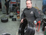 Papo Chinea holds a broken rim up for inspection at his repair shop in Queens Village, Queens. Chinea's business has grown steadily since the winter's heavy snow left potholes in the streets across New York. Photo by Nick DeSantis.