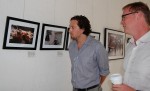 Greg Spielberg and Craig Warga admire a photo of a young couple on a ferris wheel. Photo by Kait Richmond.