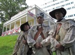 Revolutionary War re-enactors portraying soldiers of the 1st Rhode Island Regiment pose in front of the Hamilton Grange National Memorial in Harlem, Manhattan. From left to right: Thom Wooten, Fred Minus and Leon Brooks of Trenton, N.J. Photo by Louie Lazar