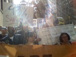 Protestors chant at a distance from the police barricaded entrance to JP Morgan CEO Jamie Diamond's residence. Photo by Eric Zerkel