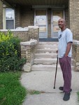 Juan Scott, 54, stands outside of his home in West Detroit, on a block dominated by abandoned houses. Scott, who is out of work, is a long-time Lions and Tigers fan. Photo by Louie Lazar.