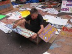 David Everitt-Carlson, 55, paints signs for Occupy Wall Street protests on Columbus Day. His advertising agency in New York went bankrupt after 9/11, leaving him unemployed and homeless. Photo By: Mina Sohail