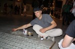 Erik Hendrickson, 24, of Trenton, NJ constructs his flag made of money at the "No Comment" art exhibit. Photo by Ebony Montenegro