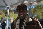 Claude Jay, a Harlem-based performer and business owner, acted as emcee of the Gospel Station singing and welcoming runners into the 21st mile of the race.  Photo byJoann Pan