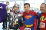 Hideki Kinoshita (left) and Steve Shannon (right) pose for pictures for fellow runners on their way to board the Staten Island Ferry to reach the start of the 2011 ING New York City Marathon.  Photo by Eric Zerkel