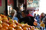 Maylei Zhou (center), a Shanghai native who has been living in Flushing for the past 20 years, shops for fruits outside the Ou Jiang Supermarket on the corner of Main Street and 40th Road in Flushing, Queens on Saturday. Photo by Alexa Mae Asperin