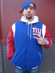 Anthony Lopez, a 27-year-old maintenance worker from Alphabet City, poses with pride in his commemorative Giants Super Bowl jacket.