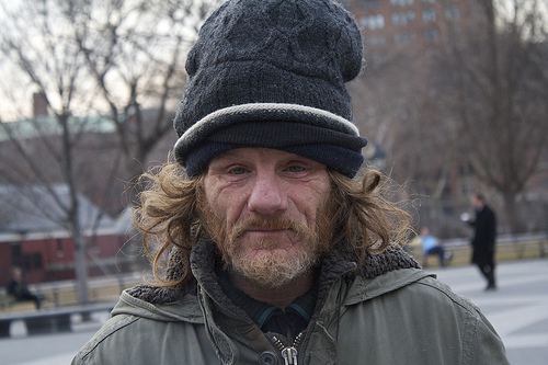 Larry Reddick, 47, spends his nights on the steps of Judson Memorial Church, where he bundles up in stacks of cold weather gear donated to him over time. - 6873340141_88624acecf