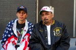 Lauren DeLucia of North Bergen, N.J. sits with her father, Marco, one block away from private ceremonies for families at New York's 11th anniversary ceremony of Sept. 11. DeLucia and her father volunteered for search and rescue and cleanup teams days immediately after the Sept. 11 attacks. Photo by Timothy Weisberg