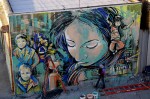 Artist Alice Pasquini is shown painting her latest mural. She traveled from Rome to be a part of the Bushwick magnet. Photo by Gabrielle A. Wright.