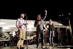 Founders of United Photo Industries Sam Barzilay (left), Dave Shelley (center) and Laura Roumanos (right) make opening speeches at Photoville. a photo exhibit in Brooklyn. Photo credit: Christina Dun