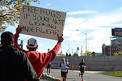 Carlos Almendarez holds a sign for the runners in The Bronx. Photo by Christina Dun