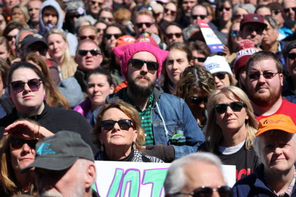 The crowd, including a man wearing a pussy hat, listen to speakers at March for Our Lives in Washington, D.C.