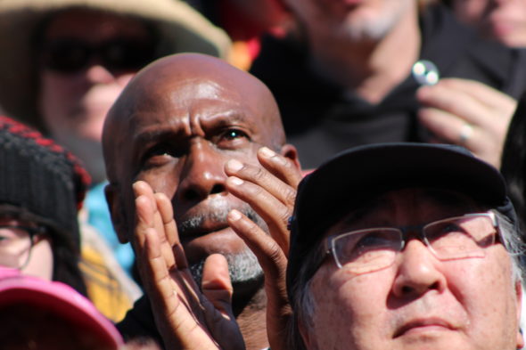 A protester claps while he listens to speakers at March for Our Lives in Washington, D.C.