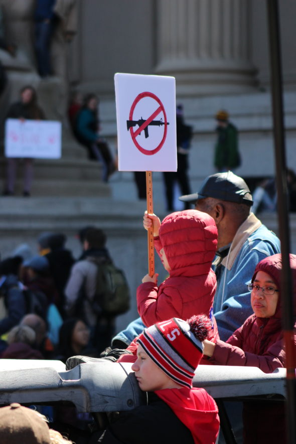 A child holds up an anti-gun protest sign at March for Our Lives in Washington, D.C.
