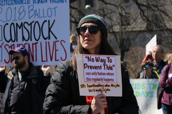 A protester holds up a sign that says "No way to prevent this, says the only nation where this regularly happens" at March for Our Lives in Washington, D.C.